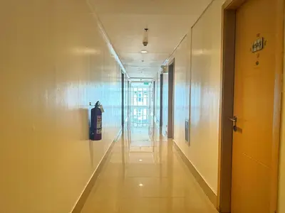a hallway of a building with a fire extinguisher at New Cozy 2-bedroom deluxe condo for 5 pax in MOA in Manila