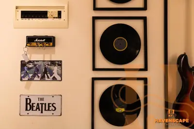a wall with a bunch of records and a guitar at Havenscape Staycation in Manila