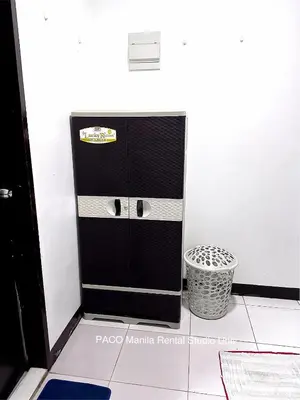 a black cabinet in a room with a trash can at Paco Manila Rental Studio Unit in Manila