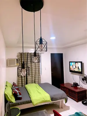 a bedroom with two lights hanging above a bed at Paco Manila Rental Studio Unit in Manila