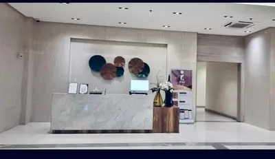 a lobby with a reception desk and a counter at Aura Zen Suites condotel in Manila