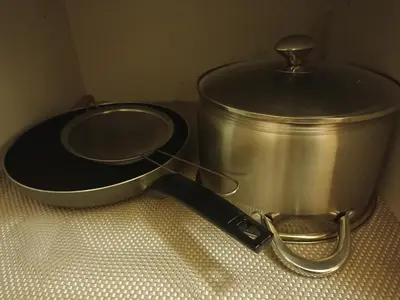 a slow cooker and a pot on a table at Lovers' Cozy 1BR Condo Near Mall and Airport with Free Netflix Premium and 100 MBPS WiFi in Manila