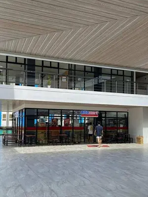 a man is standing in front of a building at Enzo vibes in Manila