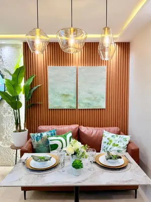 a dining room with a table and a couch at 1-Bedroom Cozy Haven Sorrento Oasis in Manila