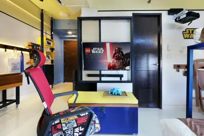 a room with a desk and a chair and a tv at Starwars Retreat Gaming & 84 inch Movie & Near Mall in Manila