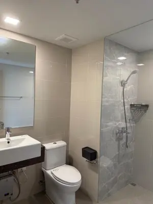 a bathroom with a shower and a toilet and a sink at HomeMadeLuxury 3 Bedrooms Seaview Sunset View Near Manila Airports Okada MOA in Manila