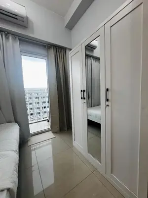a room with a bed and a large window at MOA GRAND STAY Suite #05 Spacious Unit & Sun Rise View in Manila