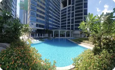 a large swimming pool in front of a tall building at 1BR at the FORT BGC near Malls, Restaurants & Shops in Manila