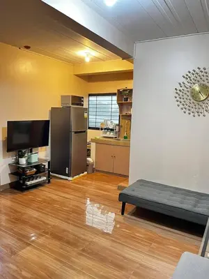 a large room with a kitchen and a living room at Staycation in Alabang in Manila