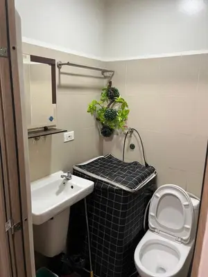 a bathroom with a sink and a toilet and a plant at Smdc Coast Resideces in Manila