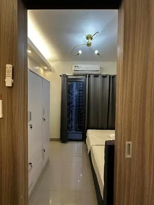 a bedroom with a bed and a ceiling fan at Cozy MOA Condo Perfect for 2 in Manila