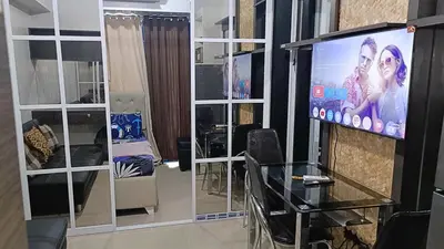 a living room with a flat screen tv on a wall at Basic one-bedroom condo at Sea Residences in Manila