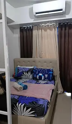 a bunk bed with pillows on it in a room at Basic one-bedroom condo at Sea Residences in Manila