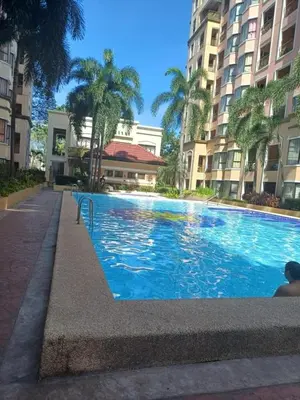 a large swimming pool in front of some buildings at 1 bedroom condo unit for 4 with balcony, pool, WIFI at Newport across NAIA T3 in Manila
