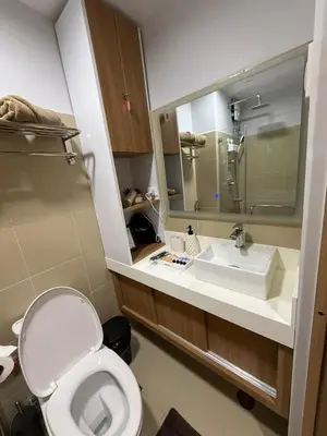a bathroom with a toilet and a sink at Shore 3 Residences with WiFi, Balcony, Pool in Manila