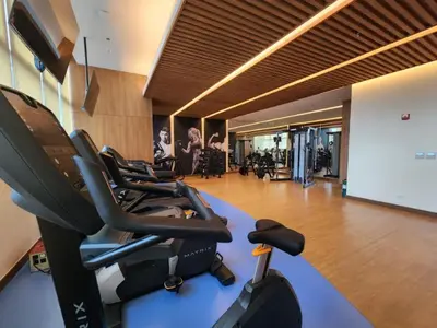 a gym with several exercise bikes in a room at Your Stylish City Escape in Park Mckinley West with Breathtaking Views in Manila