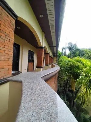 a hallway of a building with a walk way at La Traviesa Hotel Resort in General Trias