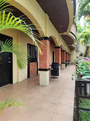 an empty hallway in a building with plants at La Traviesa Hotel Resort in General Trias
