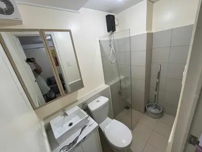 a bathroom with a toilet and a sink and a shower at Enzo vibes bnb in Manila