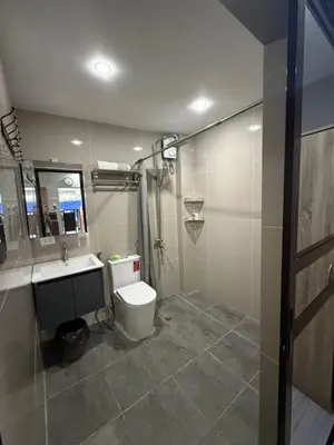 a bathroom with a toilet and a sink and a shower at Studio Room near Circuit Makati in Manila