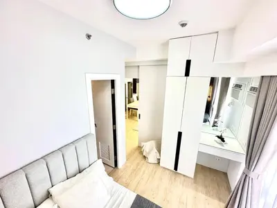 a living room with a couch and a mirror at Stylish Luxe Apt in Gentry Manor in Manila
