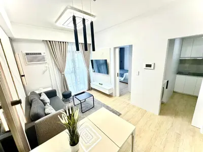 a living room with a couch and a table at Stylish Luxe Apt in Gentry Manor in Manila