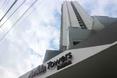 a sign on a building with a tall building at Dreamy Studio with Netflix and High Speed Wifi in Manila