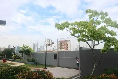 a woman is playing basketball on a basketball hoop at Dreamy Studio with Netflix and High Speed Wifi in Manila