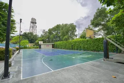 a tennis court with a basketball hoop at Comfortable 3-Bedroom Stay in Pasig The Rochester in Manila