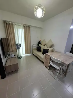 a living room with a couch and a table at Comfortable 3-Bedroom Stay in Pasig The Rochester in Manila