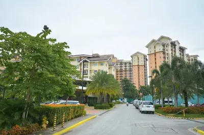 a street with cars parked on the side of a building at Comfortable 3-Bedroom Stay in Pasig The Rochester in Manila