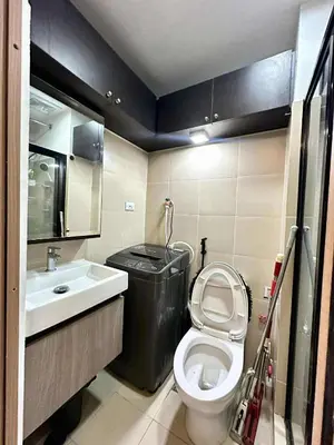 a small bathroom with a toilet and a sink at JOYCE LARA Staycation in Manila