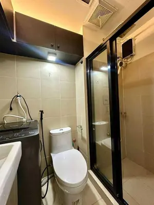 a small bathroom with a toilet and a shower at JOYCE LARA Staycation in Manila