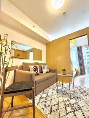 a living room with a couch and a table at Celebrity Stays in Manila