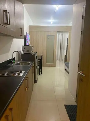 a kitchen with a sink and a counter top at Shore residence A41 shortwalk mall of asia in Manila
