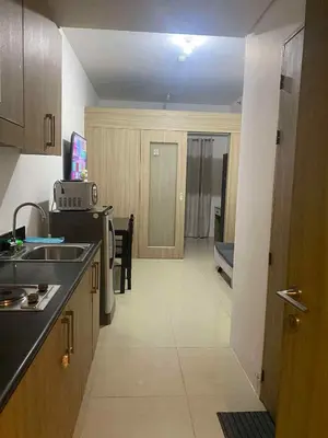 a kitchen with a sink and a counter top at Shore residence A41 shortwalk mall of asia in Manila
