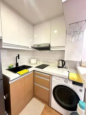 a kitchen with a sink and a dishwasher at Kali's Pad in Manila