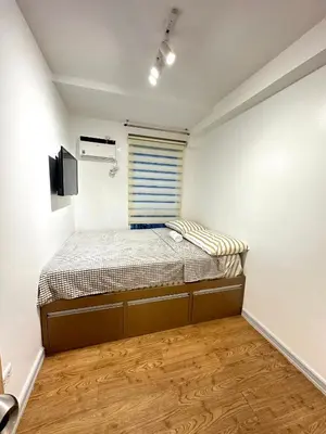 a small bedroom with a bed and a window at Kali's Pad in Manila