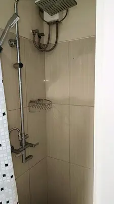 a shower with a shower head in a bathroom at Spacious simple one-bedroom condo at Shell Residence in Manila