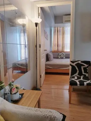 a living room with a couch and a bed at Azure Urban Resort Residences in Manila