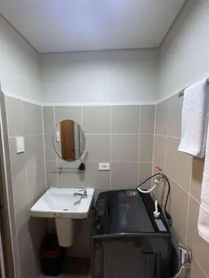 a small bathroom with a sink and a mirror at Cozy 1 Bedroom unit in Manila in Manila