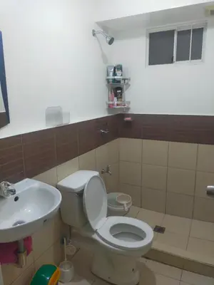 a bathroom with a toilet and a sink at May homey vibe in Pasig