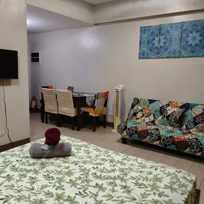 a living room with a couch and a table at LDN Secret Crib 5K- Two Palm Tree in Manila