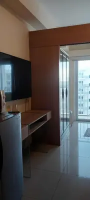 a room with a desk with a television and a window at Dona staycation in Manila