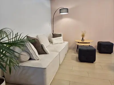 a living room with a couch and a table at Modern Bright Cozy Stylish 1BR Venice BGC Balcony in Manila