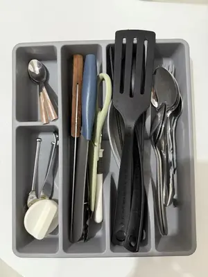 a tray filled with utensils and utensils at Red Residences Cozy Condo in Makati Near NAIA in Manila