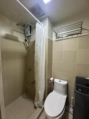 a bathroom with a toilet and a shower in it at JM's CRIB in Manila