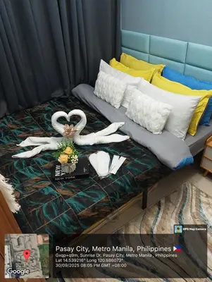 a bed with a couple of swans on it at SkyShore Suites in Manila