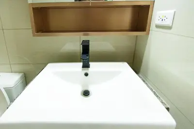 a small bathroom with a sink and a toilet at cityscapethe39th at Eastwood Global Plaza - Luxury Residences in Manila