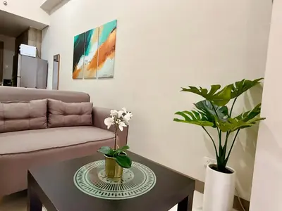 a living room with a couch and a table at Coast Residences 40th Floor Penthouse Pasay Manila in Sampong